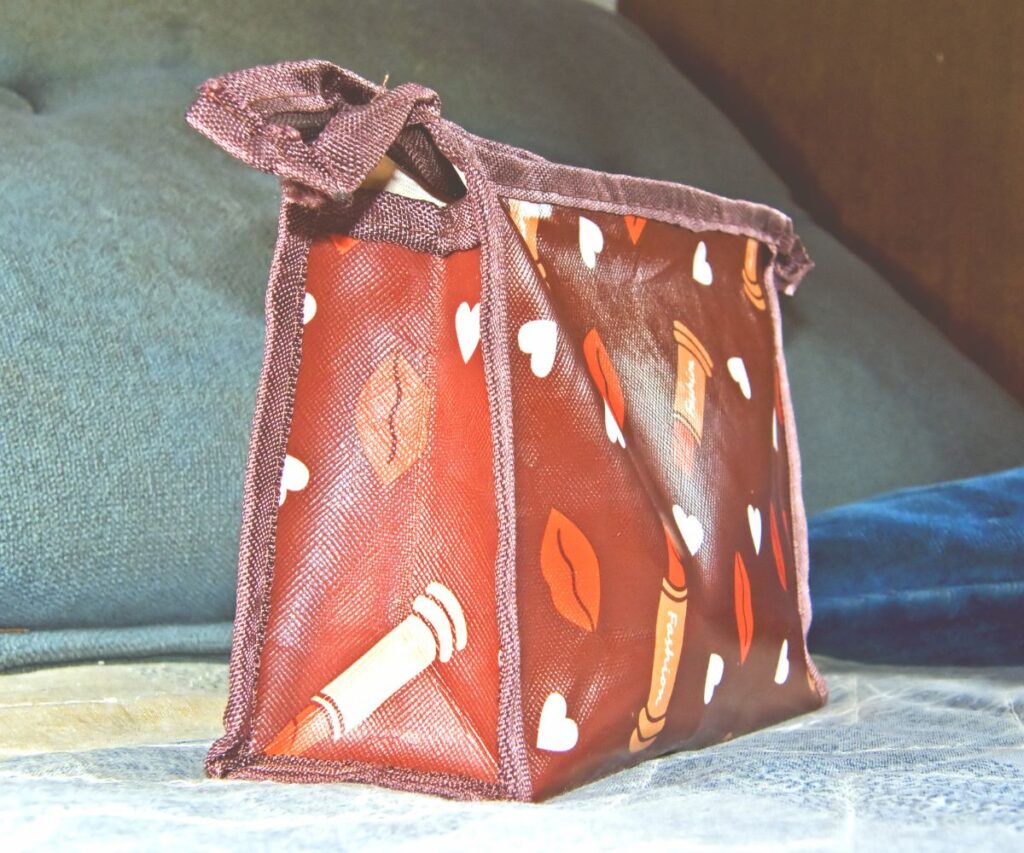 a red makeup bag sitting on a table